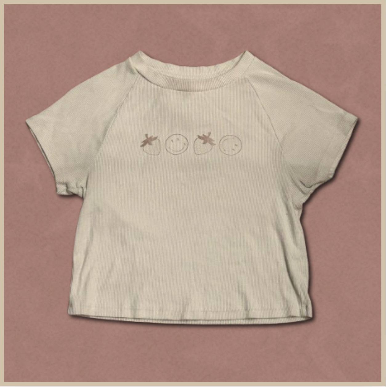 pale beige crop top with smiley/strawberry design