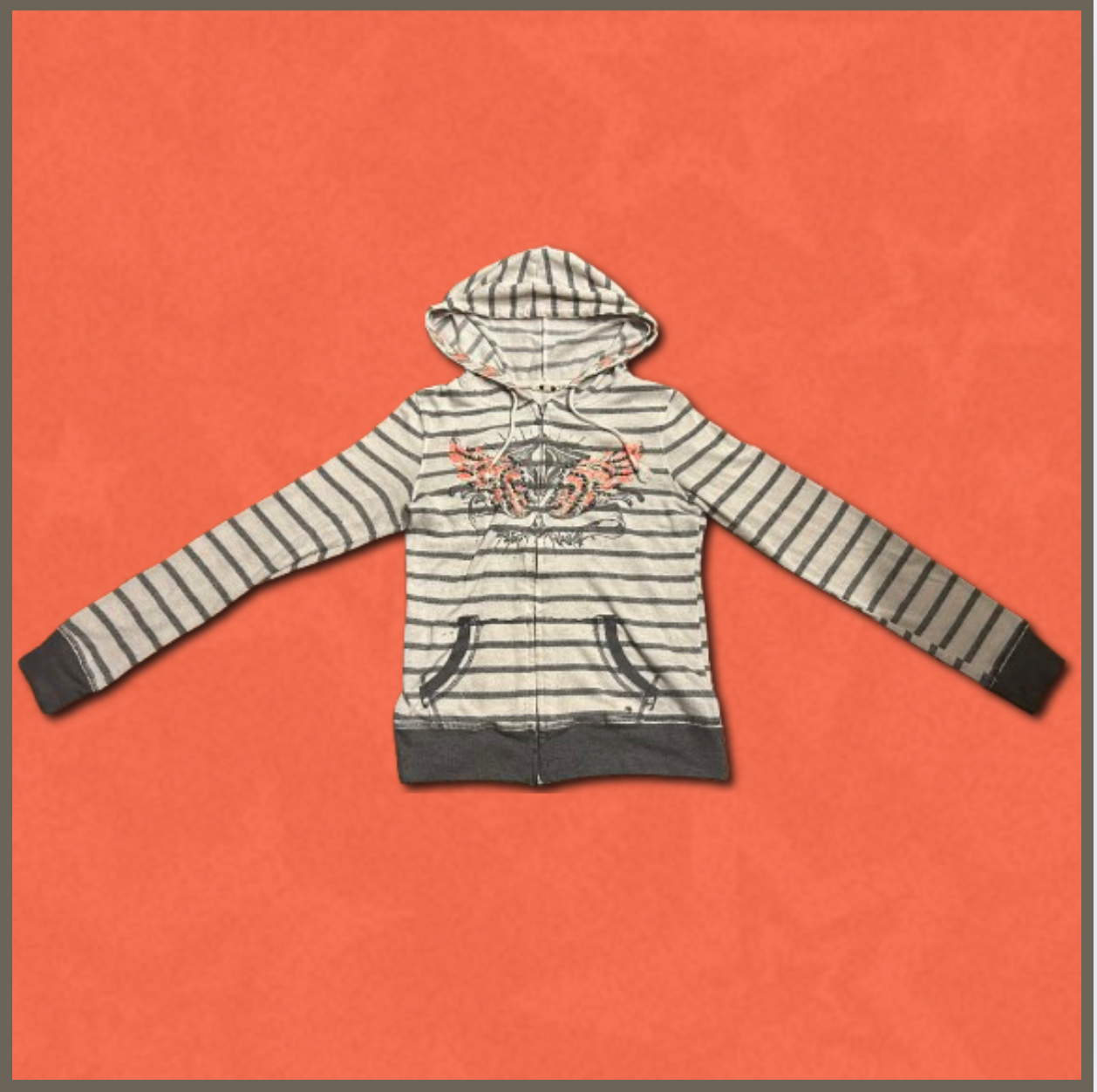 gray striped zip-up sweater with orangish-pink wing design