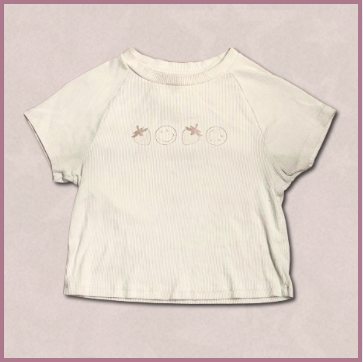 pale beige crop top with smiley/strawberry design