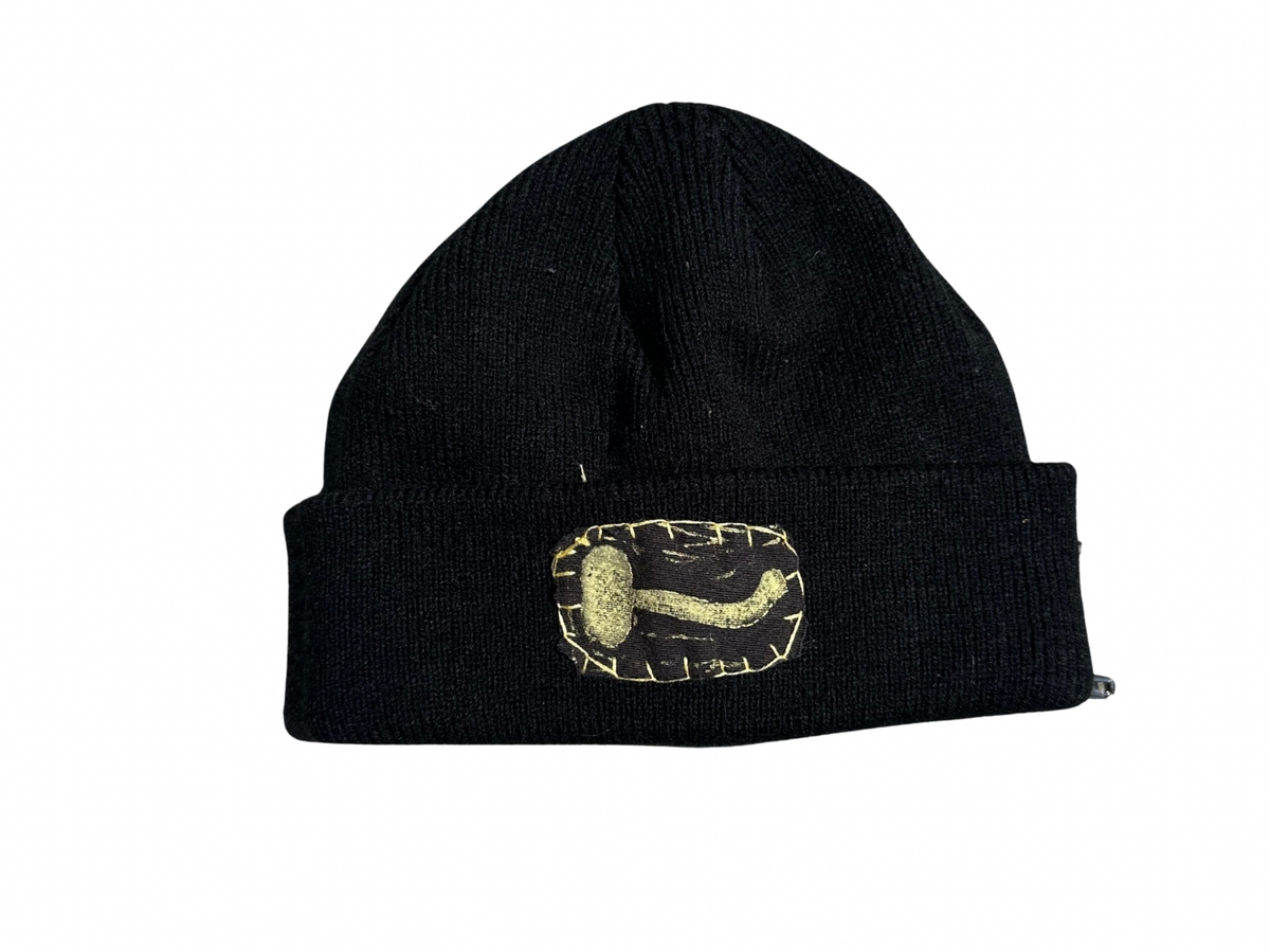 black beanie with gold mushroom patch